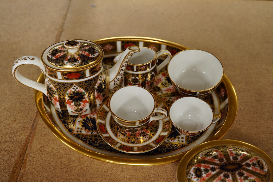 A small collection of Royal Crown Derby miniature tea for two and a pill box, tray 19cm wide. Saucer missing on tea for two.